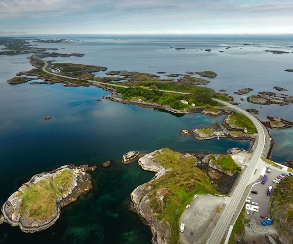 Scenic mountain roads including Trollstigen, Geirangerfjord, and Atlantic Ocean Road serpentine driving routes for car rentals in Norway